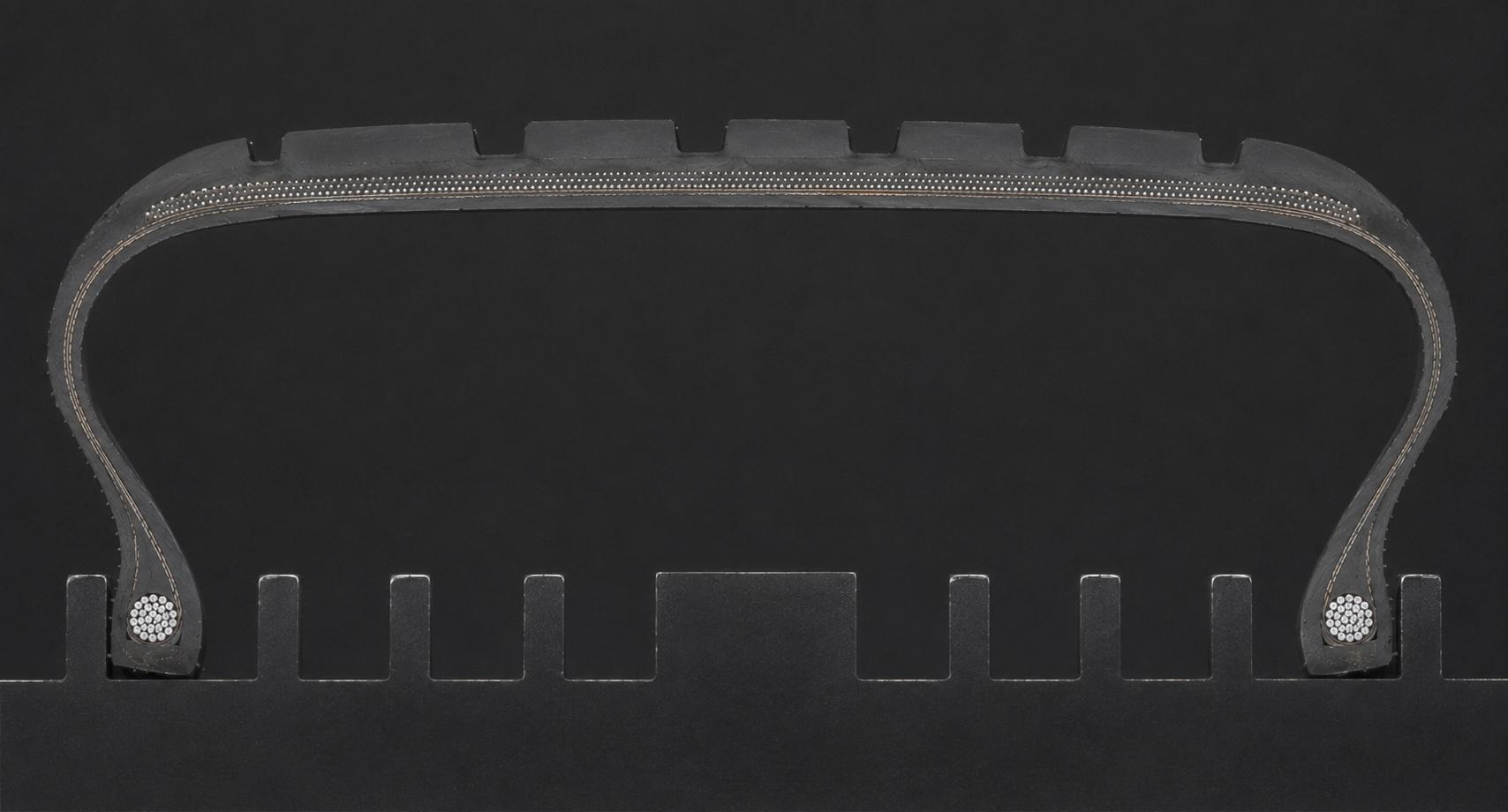 Photograph of a physical tyre cut-section against a dark background